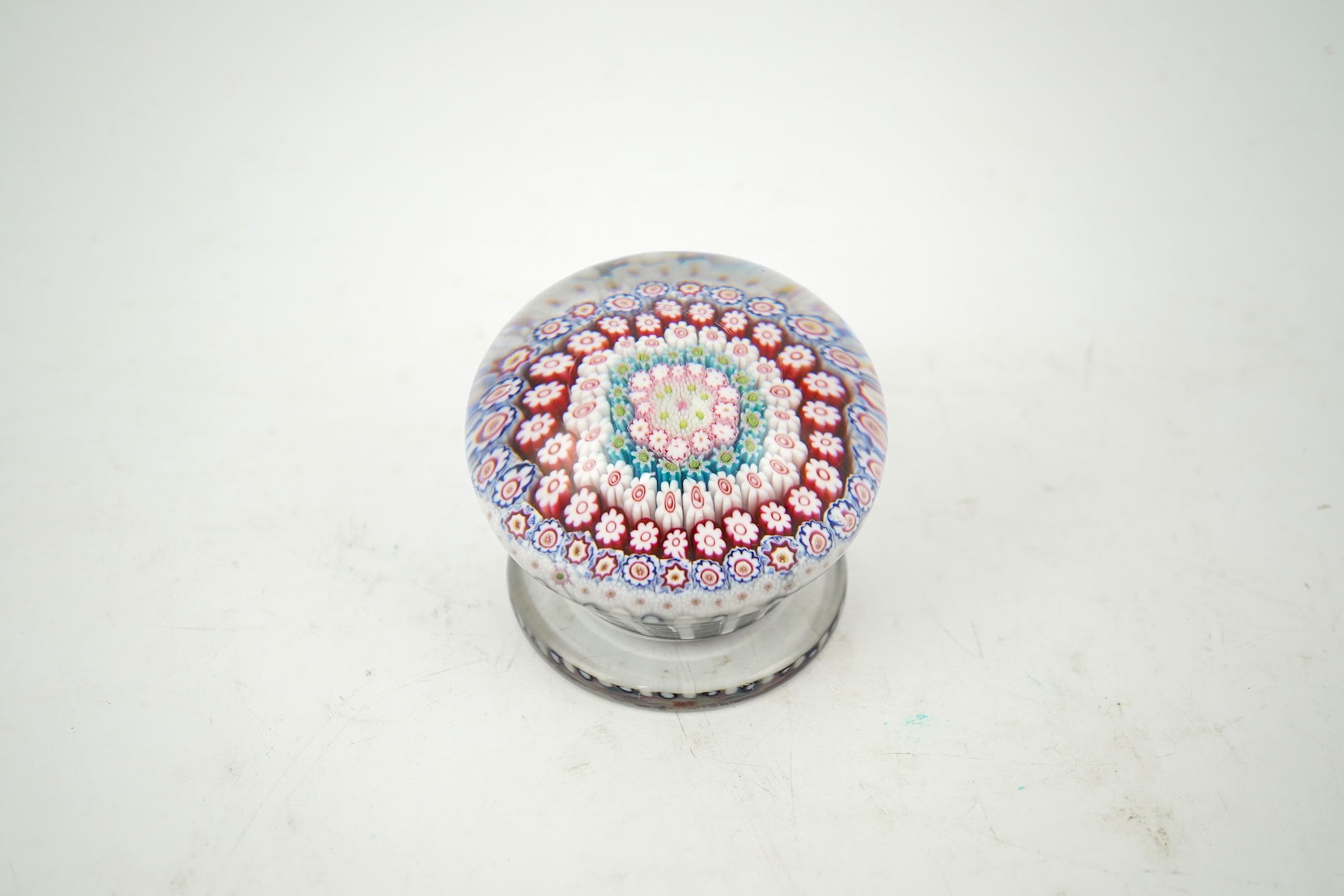 A Clichy piedouche concentric millefiori paperweight, mid 19th century